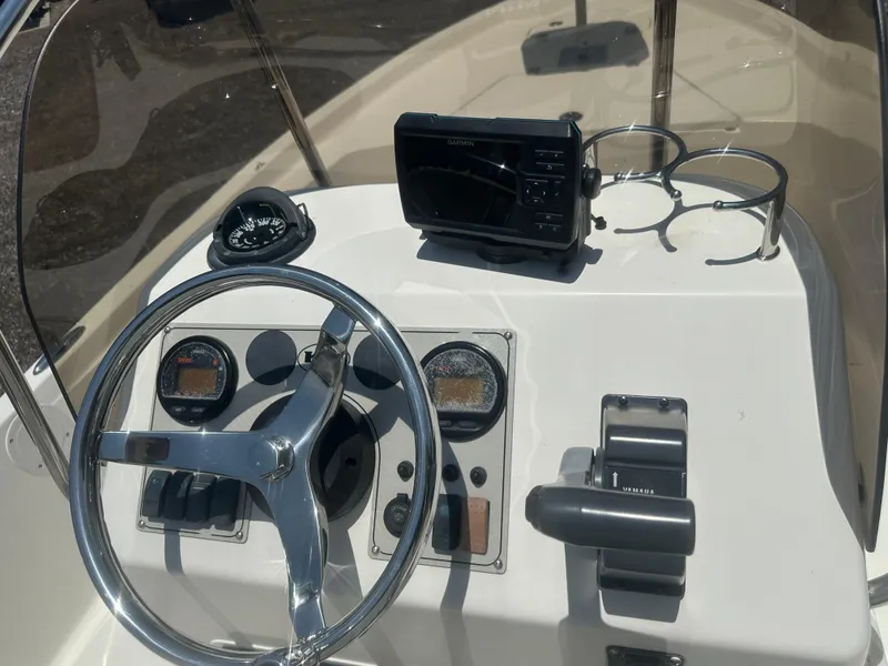 Slide: The Image of Console of 2008 Key West 186 Bay Reef boat with steering wheel and navigation equipment. - 18