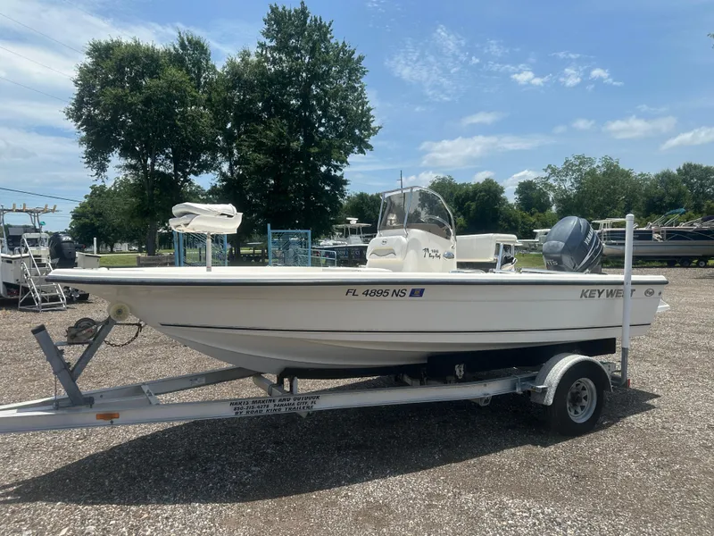Slide: The Image of 2008 Key West 186 Bay Reef boat on trailer, parked outdoors under a clear sky. - 2