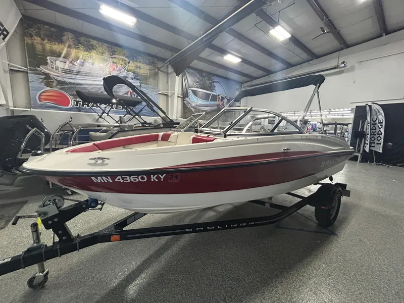 Slide: The Image of 2013 Bayliner 185 Bowrider boat on trailer in indoor showroom. - 5