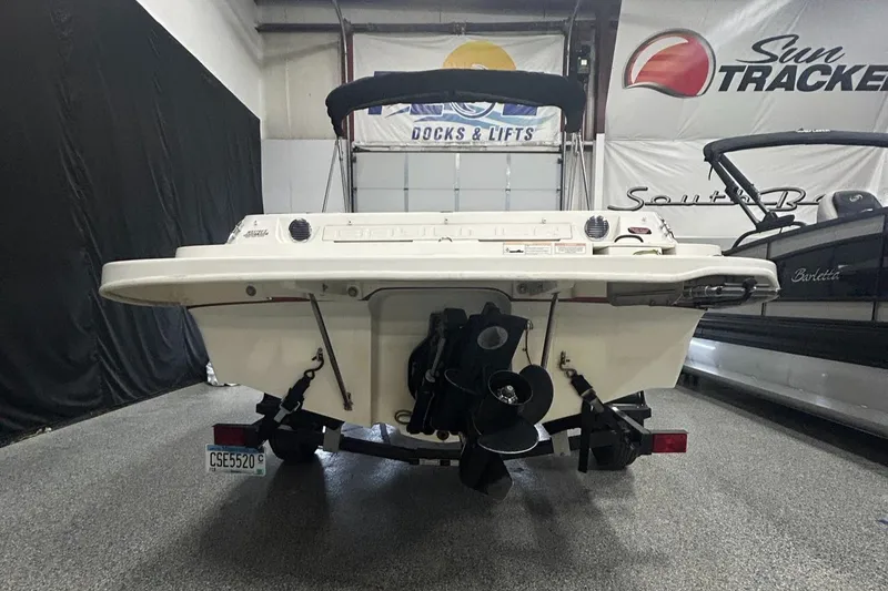 Slide: The Image of 2013 Bayliner 185 Bowrider boat, rear view in showroom, featuring outboard motor. - 6