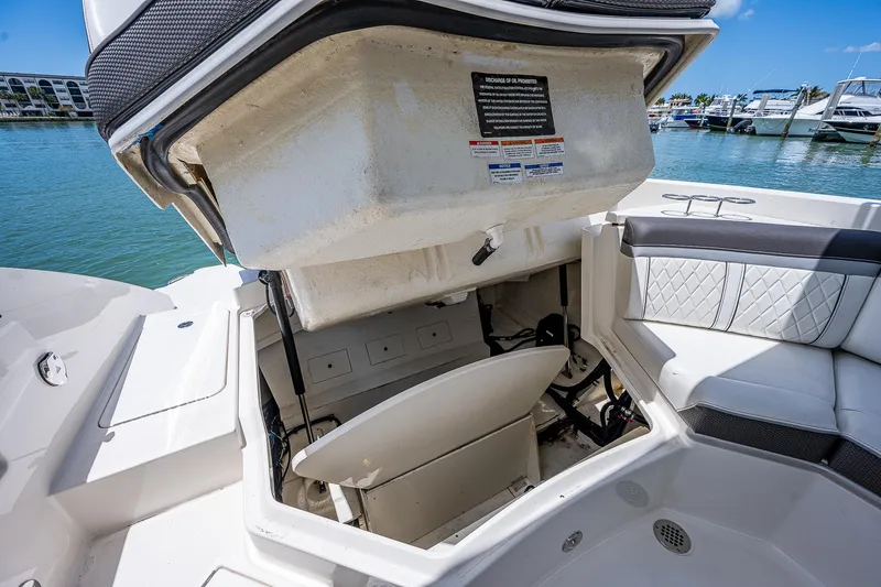 Slide: The Image of 2017 Sea Ray 31 SLX boat with open storage compartment. - 22