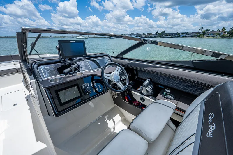 Slide: The Image of 2017 Sea Ray 31 SLX boat cockpit with modern controls and waterfront view. - 24