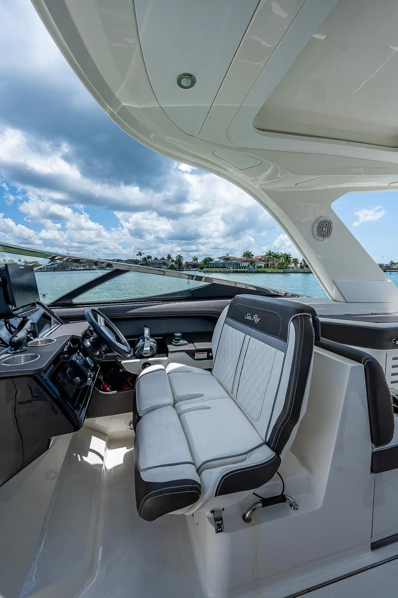 Slide: The Image of 2017 Sea Ray 31 SLX boat interior with luxurious seating and modern dashboard. - 27