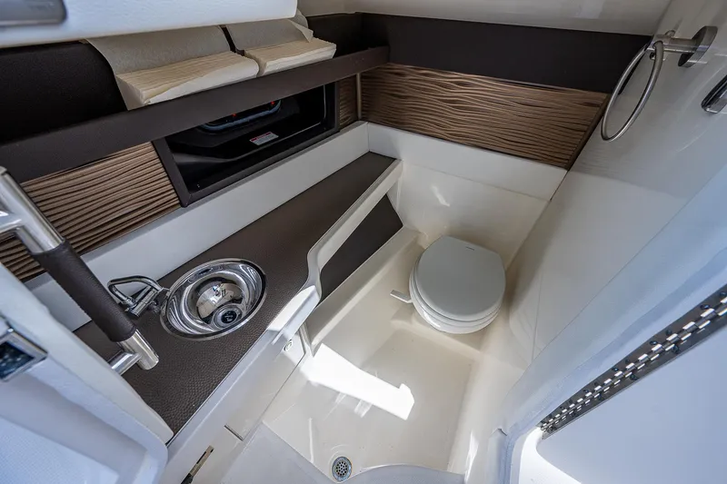 Slide: The Image of 2017 Sea Ray 31 SLX boat interior bathroom with sink and toilet. - 28