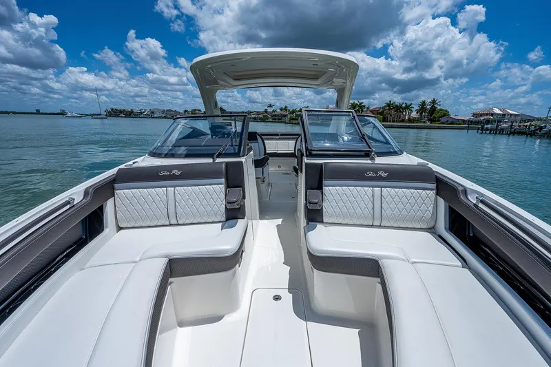 Slide: The Image of 2017 Sea Ray 31 SLX boat interior with luxurious seating on a sunny day. - 30