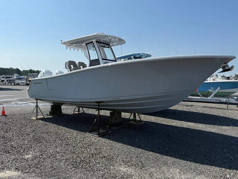 Slide: The Image of 2025 Sportsman Open 262 Center Console boat on display in a marina. - 0
