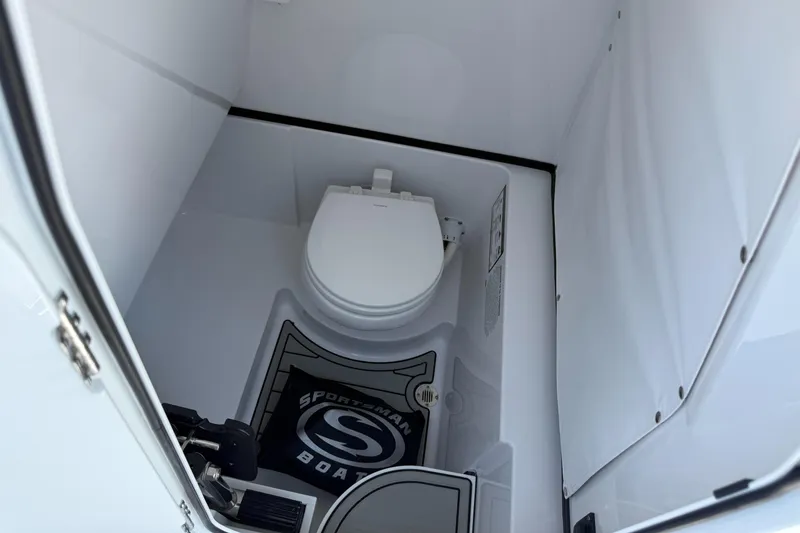 Slide: The Image of 2025 Sportsman Open 262 Center Console boat interior with toilet. - 10