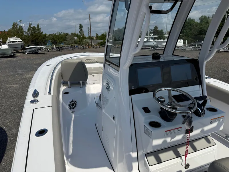 Slide: The Image of 2025 Sportsman Open 262 Center Console boat with modern dashboard and seating. - 3