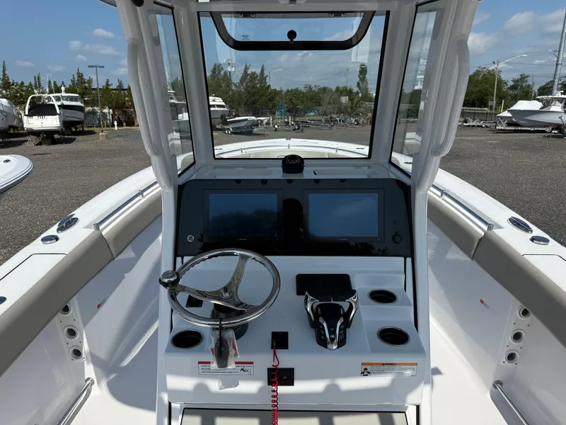 Slide: The Image of 2025 Sportsman Open 262 Center Console boat interior with steering wheel and dual screens. - 4