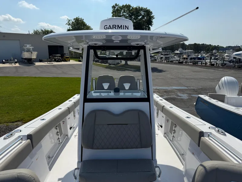 Slide: The Image of 2025 Sportsman Open 262 Center Console boat with Garmin equipment at a marina. - 7