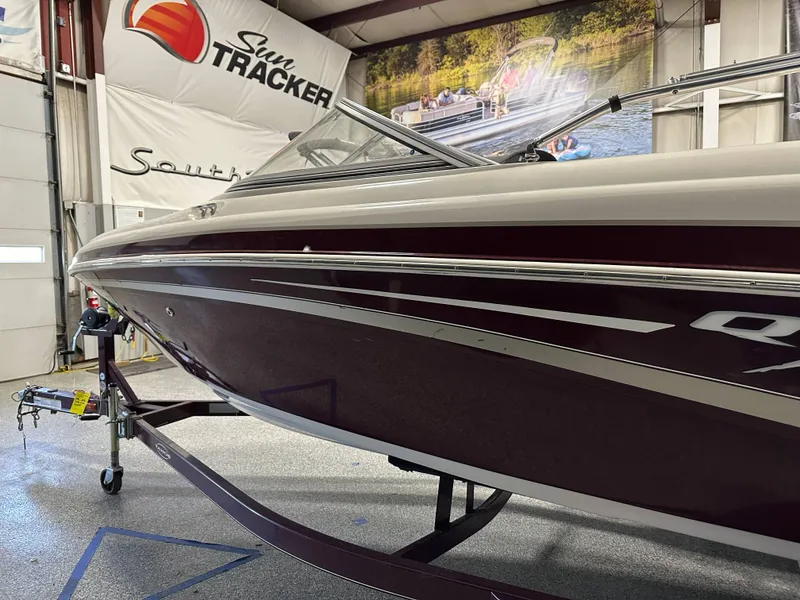 Slide: The Image of 2014 Tahoe Q7SSI boat interior with white and red seating, steering wheel, and dashboard. - 12