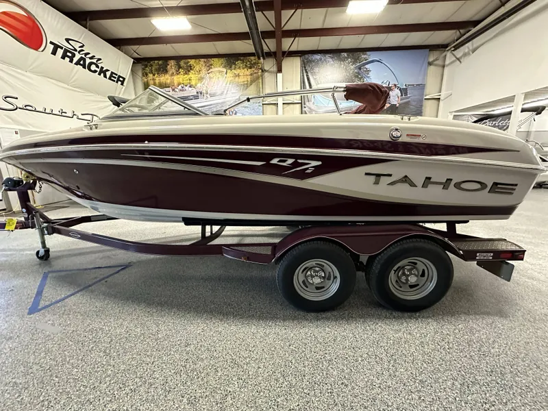Slide: The Image of 2014 Tahoe Q7SSI boat interior with white and red seating, steering wheel, and dashboard. - 13