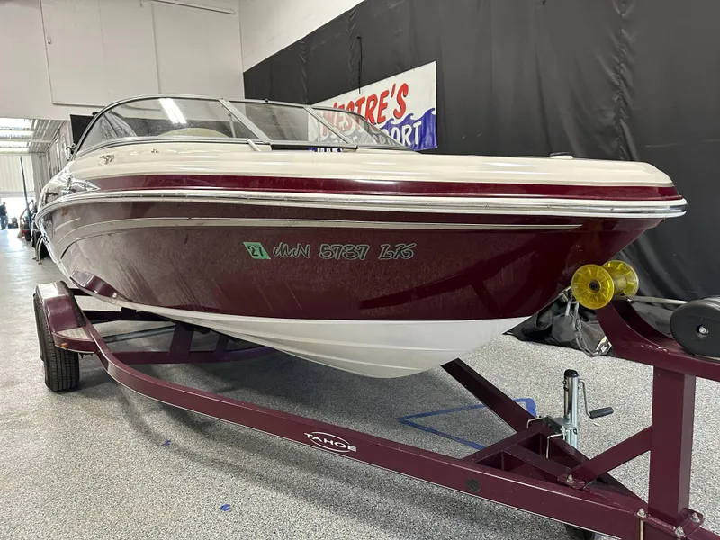 Slide: The Image of 2014 Tahoe Q7SSI boat on trailer in indoor showroom setting. - 5