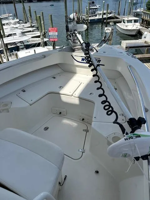 Slide: The Image of 2015 Boston Whaler 250 Outrage boat docked at marina, featuring spacious deck layout. - 10