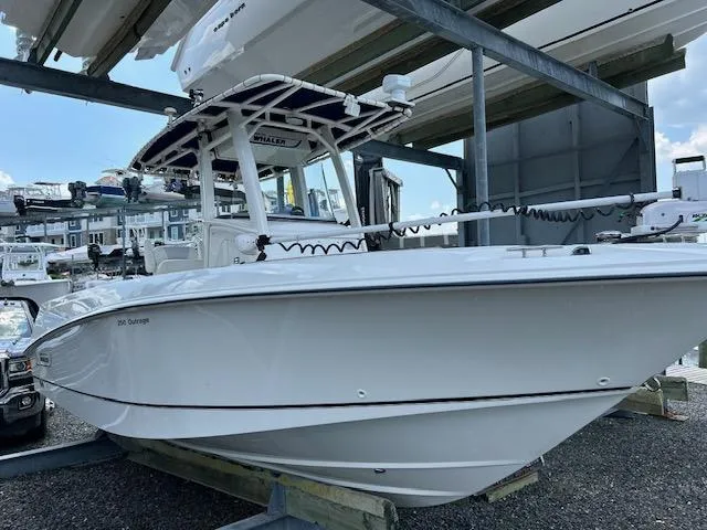 Slide: The Image of 2015 Boston Whaler 250 Outrage boat docked, showcasing sleek design and modern features. - 4
