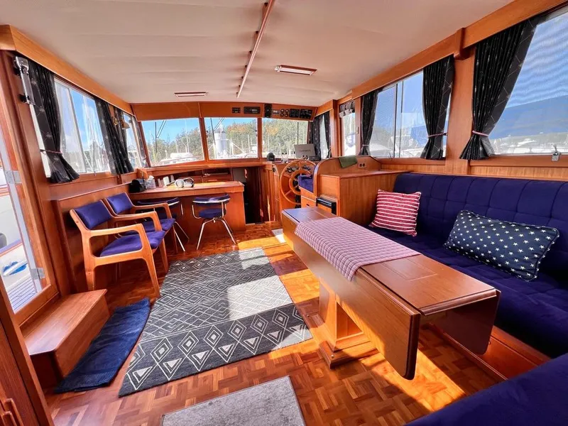 Slide: The Image of Interior of 1999 Grand Banks 42 Motoryacht with elegant wood finish and comfortable seating. - 12