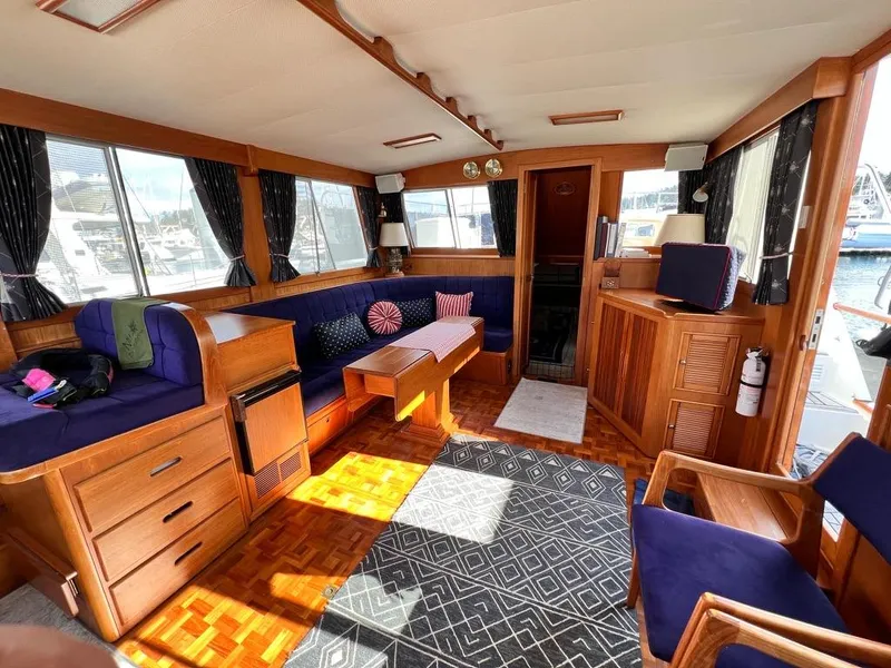 Slide: The Image of Luxurious interior of 1999 Grand Banks 42 Motoryacht with wood finish and blue seating. - 13