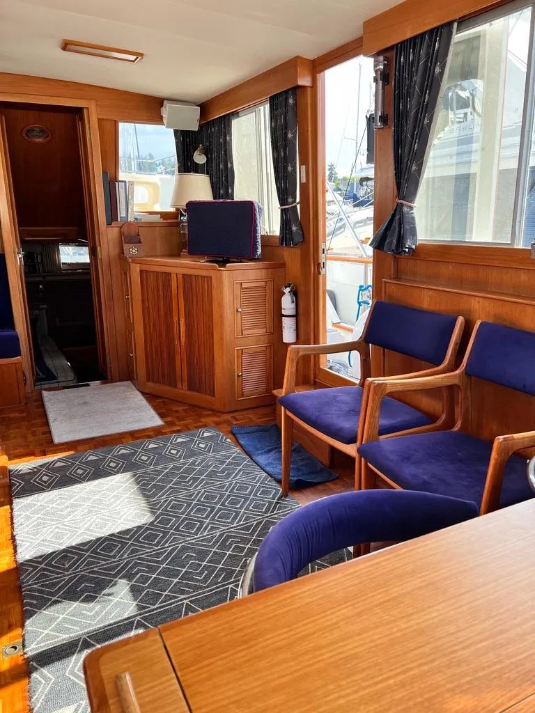 Slide: The Image of Interior of 1999 Grand Banks 42 Motoryacht with wooden furnishings and blue seating. - 15