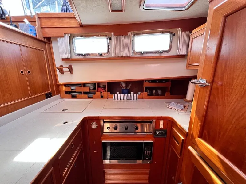 Slide: The Image of 1999 Grand Banks 42 Motoryacht kitchen with wood cabinetry and modern appliances. - 17
