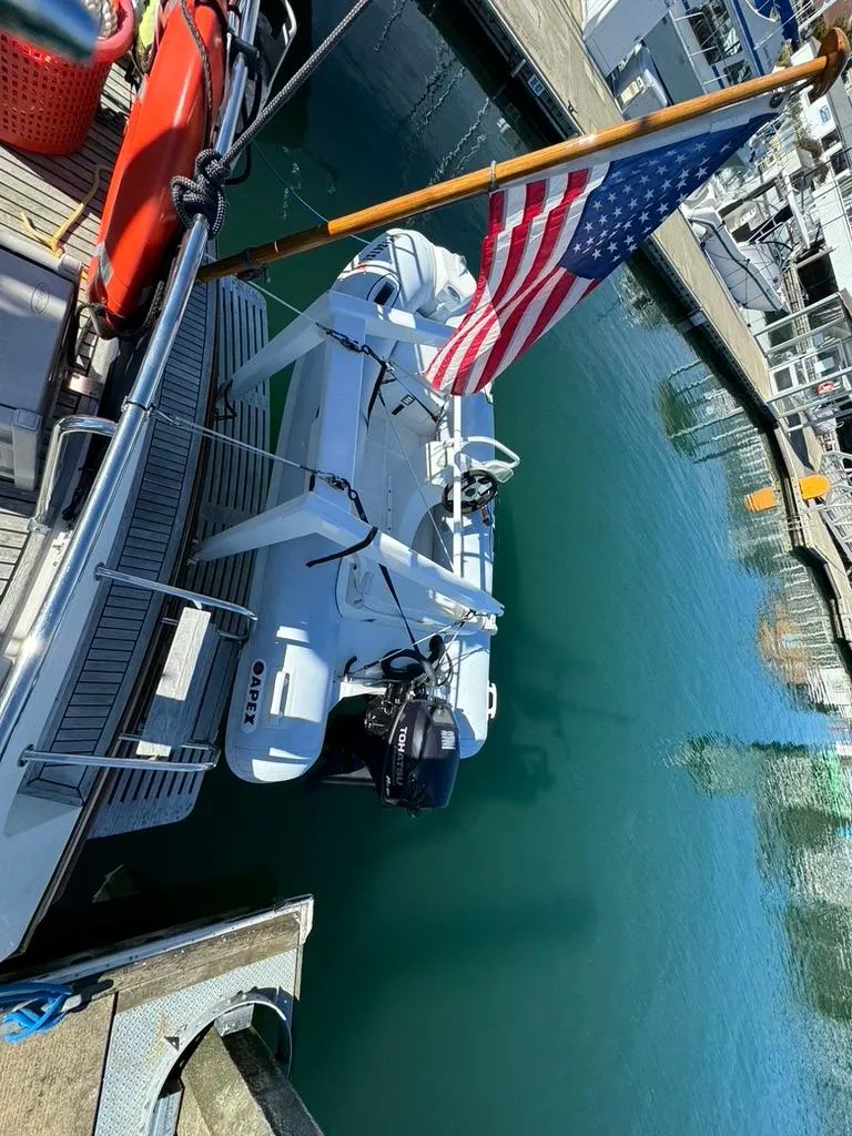 Slide: The Image of Grand Banks 42 Motoryacht (1999) docked with American flag and dinghy. - 21