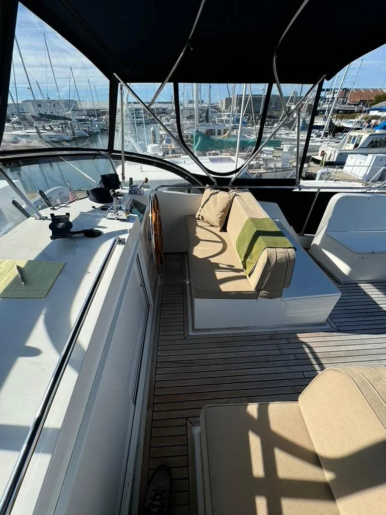 Slide: The Image of 1999 Grand Banks 42 Motoryacht interior with seating and helm, docked at marina. - 22