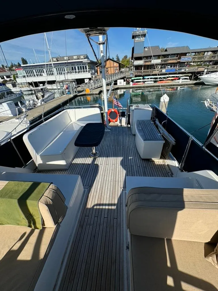Slide: The Image of 1999 Grand Banks 42 Motoryacht deck with seating, docked at a marina. - 26