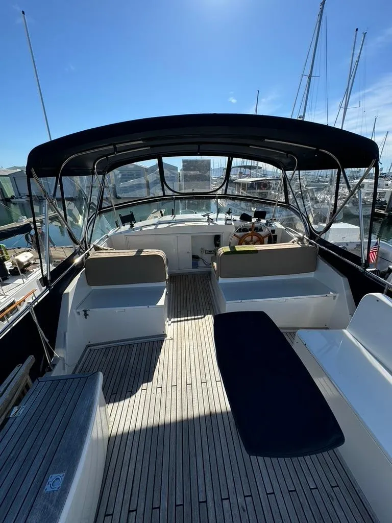 Slide: The Image of 1999 Grand Banks 42 Motoryacht deck with seating and helm, under a canopy. - 27
