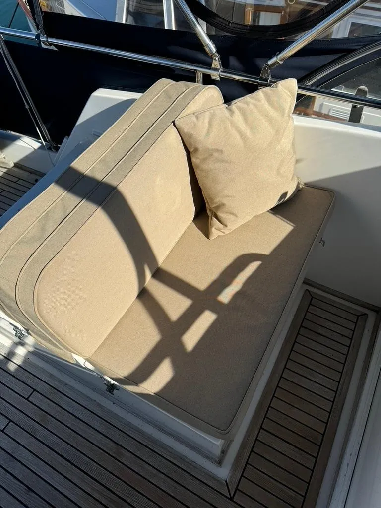 Slide: The Image of Beige cushioned seating on 1999 Grand Banks 42 Motoryacht deck, with wooden flooring. - 32
