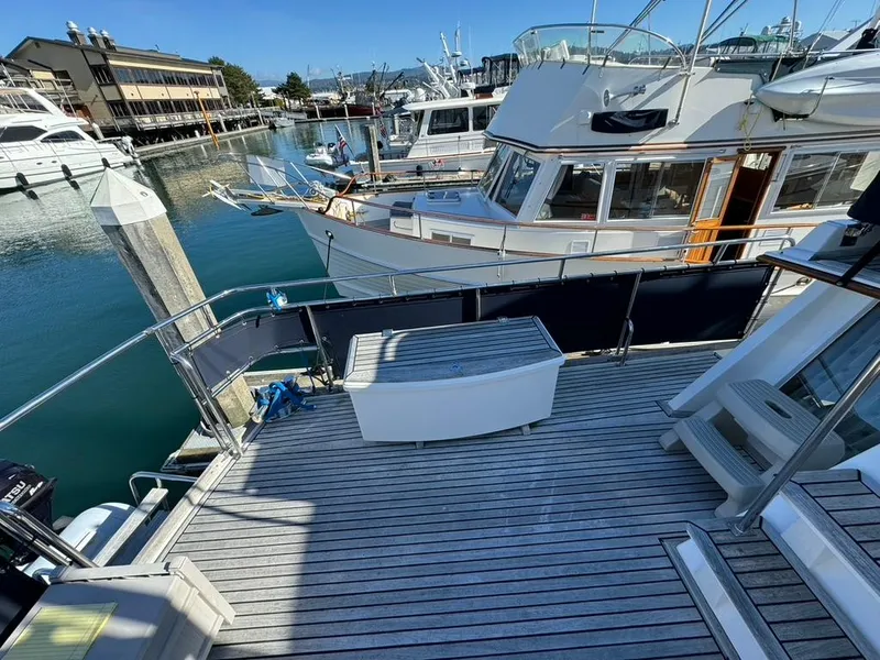 Slide: The Image of Deck view of a 1999 Grand Banks 42 Motoryacht docked at a marina. - 37