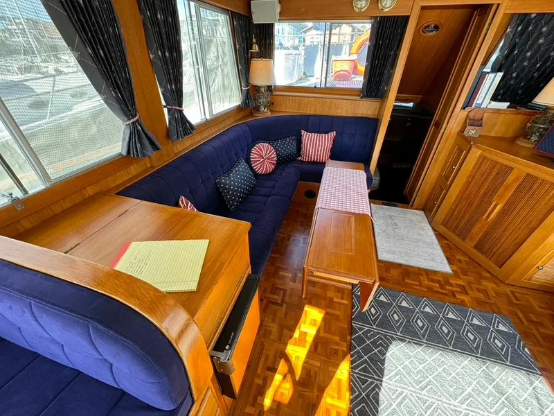 Slide: The Image of Interior of 1999 Grand Banks 42 Motoryacht with blue seating and wooden accents. - 40