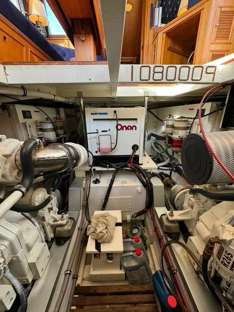Slide: The Image of Engine room of a 1999 Grand Banks 42 Motoryacht with Onan generator and mechanical components. - 45