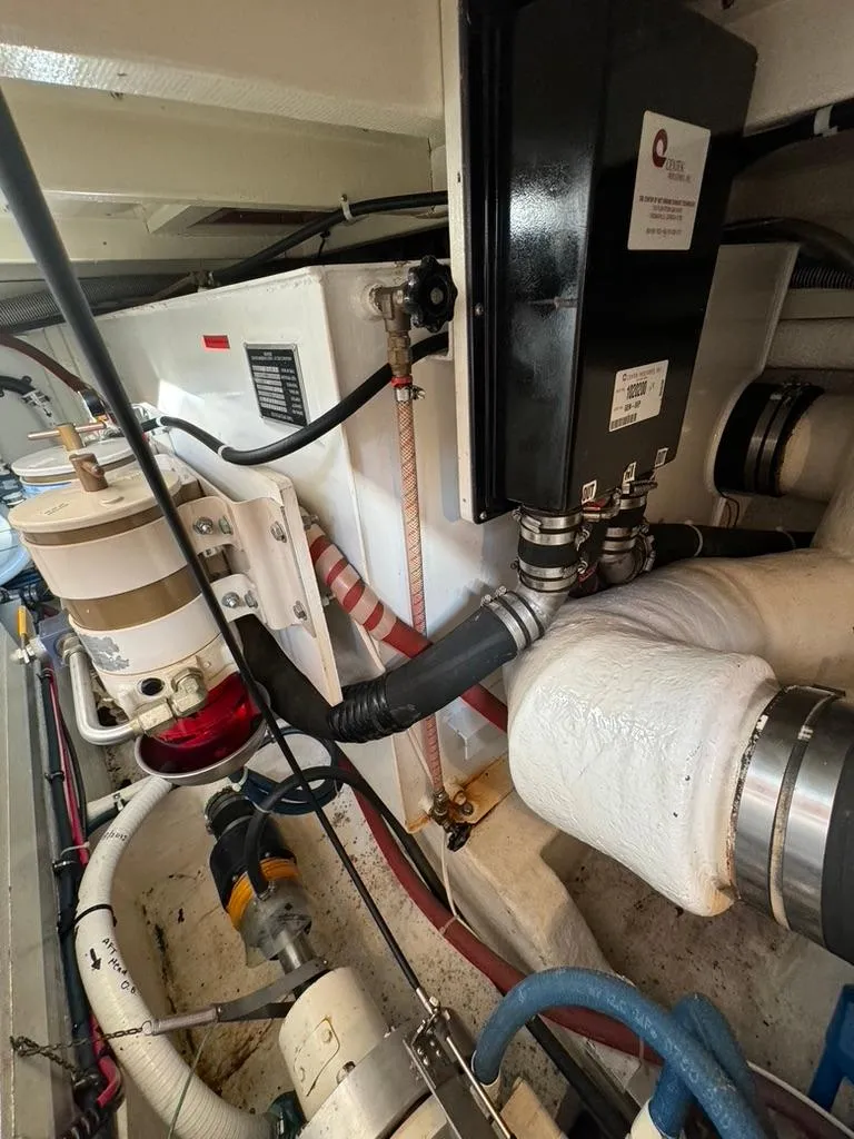 Slide: The Image of Engine room of 1999 Grand Banks 42 Motoryacht with various mechanical components. - 47