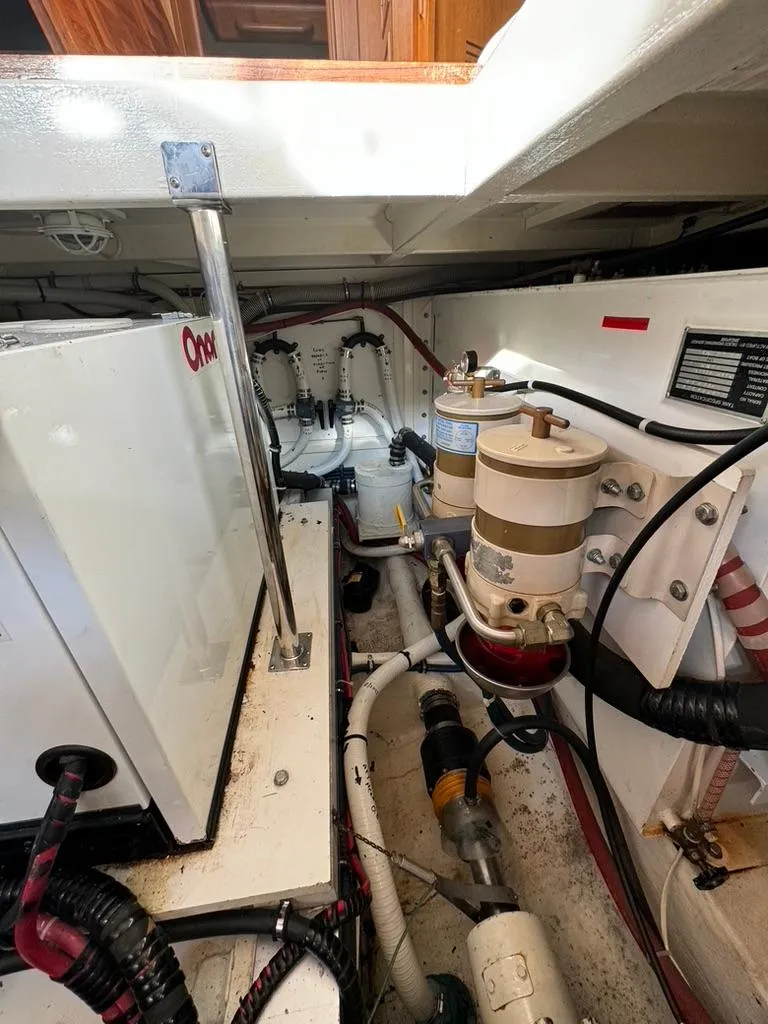 Slide: The Image of Engine room of 1999 Grand Banks 42 Motoryacht with visible machinery and components. - 48