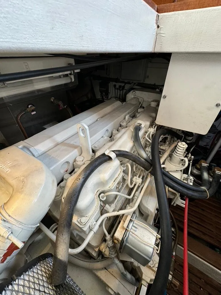 Slide: The Image of Engine compartment of a 1999 Grand Banks 42 Motoryacht, showcasing detailed mechanical components. - 49