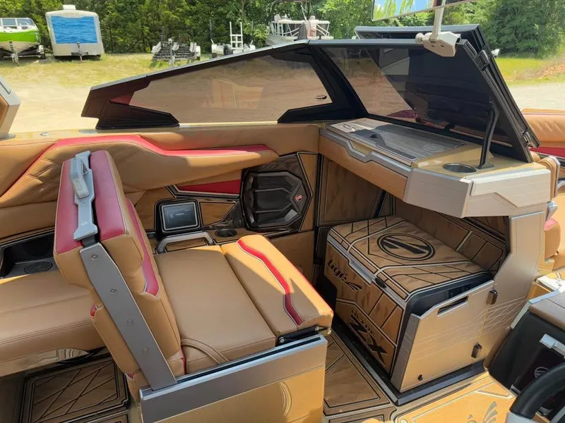 Slide: The Image of 2024 Tigé Ultré 25ZX boat interior with luxurious seating and modern dashboard design. - 12