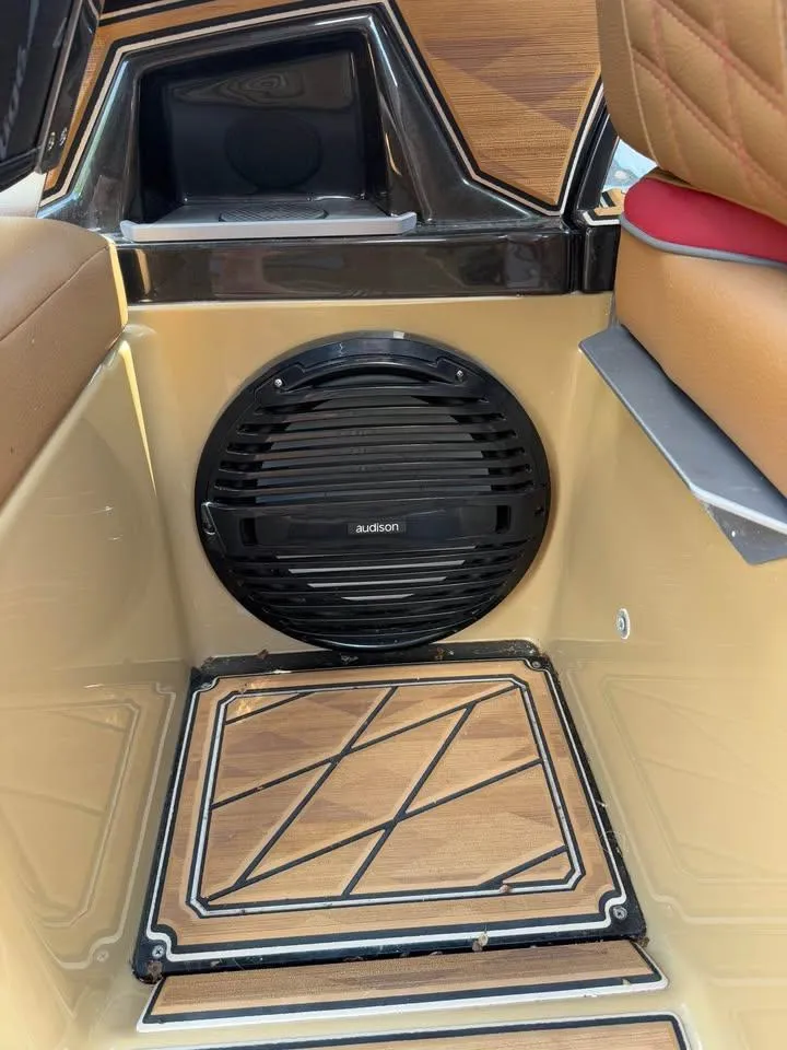 Slide: The Image of 2024 Tigé Ultré 25ZX interior with Audison speaker and stylish wood paneling. - 19