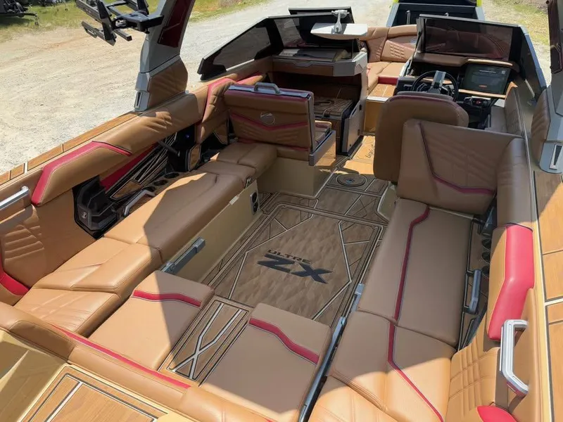 Slide: The Image of Luxurious interior of 2024 Tigé Ultré 25ZX boat with tan and red seating. - 9