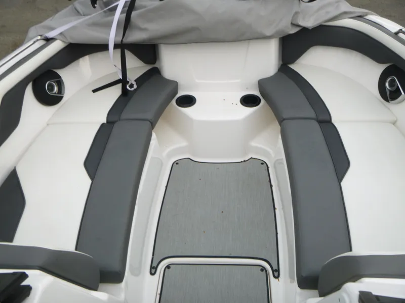 Slide: The Image of 2021 Yamaha AR210 boat interior with gray seating and cup holders. - 10