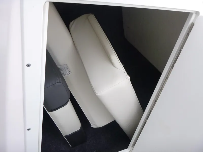 Slide: The Image of Storage compartment with cushions in a 2021 Yamaha AR210 boat. - 11