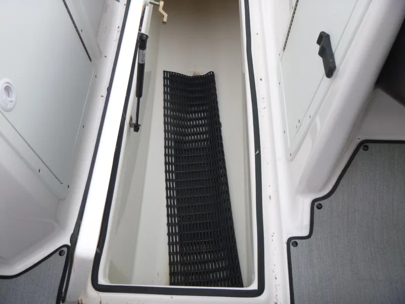 Slide: The Image of 2021 Yamaha AR210 boat storage compartment with black mat inside. - 13