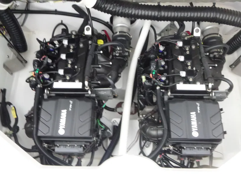 Slide: The Image of 2021 Yamaha AR210 boat engine compartment with dual engines and wiring. - 14