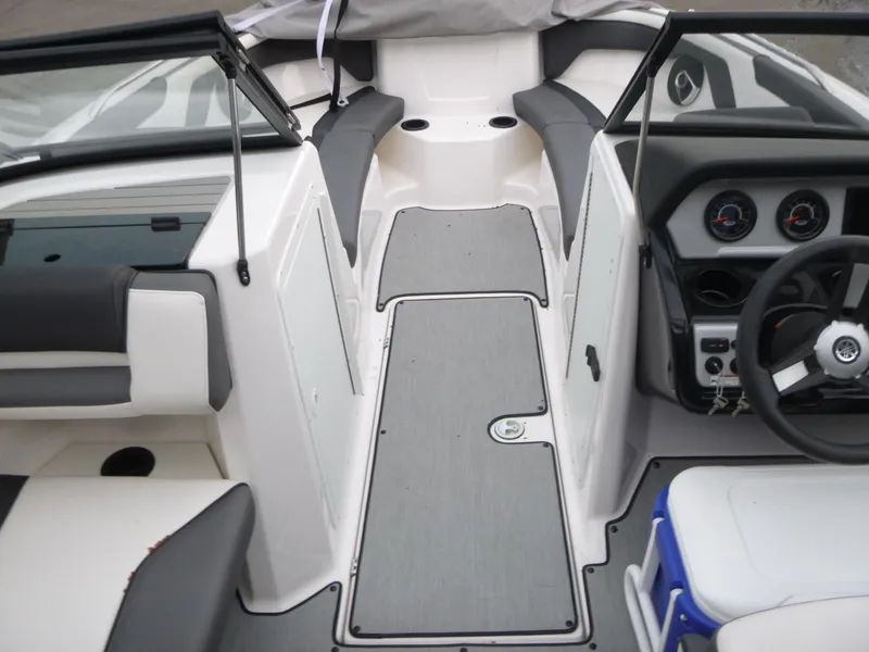 Slide: The Image of 2021 Yamaha AR210 boat interior with sleek seating and modern dashboard design. - 4