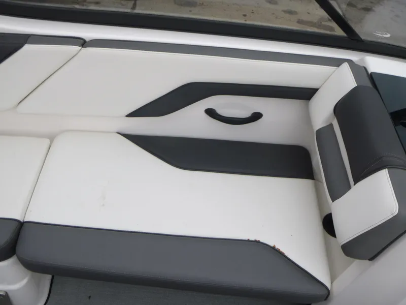 Slide: The Image of 2021 Yamaha AR210 boat interior seating with black and white upholstery. - 8