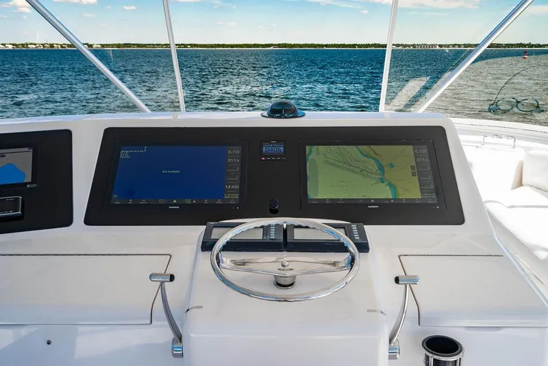 Slide: The Image of Helm of 2006 Viking 56 Convertible yacht with navigation screens and steering wheel. - 13