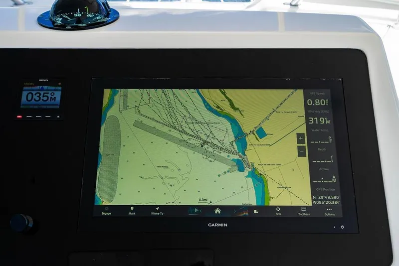 Slide: The Image of Navigation display on a 2006 Viking 56 Convertible yacht, featuring a Garmin GPS map. - 15