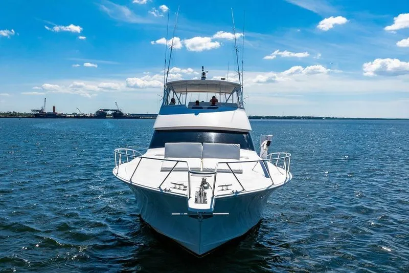 Slide: The Image of 2006 Viking 56 Convertible yacht on open water under a clear blue sky. - 2
