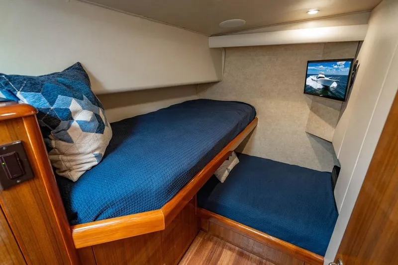 Slide: The Image of 2006 Viking 56 Convertible yacht cabin with bunk beds and wall-mounted TV. - 40