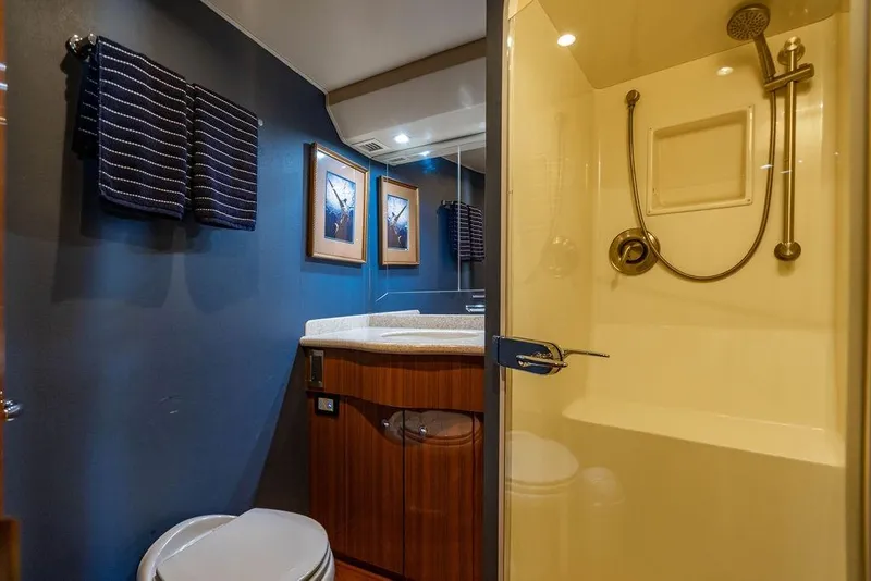 Slide: The Image of Luxurious bathroom in 2006 Viking 56 Convertible yacht with shower and elegant wood cabinetry. - 41
