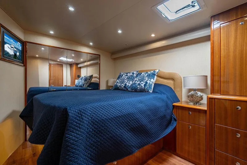 Slide: The Image of Luxurious cabin interior of 2006 Viking 56 Convertible yacht with elegant bedding and wood finishes. - 45