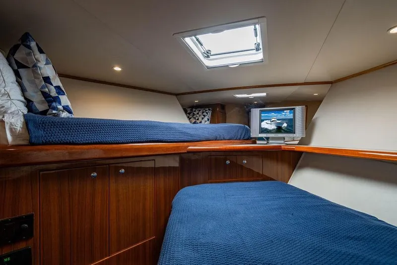 Slide: The Image of Cozy cabin interior of 2006 Viking 56 Convertible yacht with blue bedding and TV. - 51